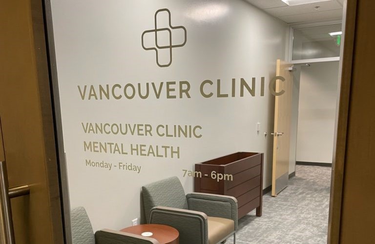 Door to a waiting room reads Vancouver Clinic