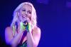 Britney Spears singing in a spotlight.