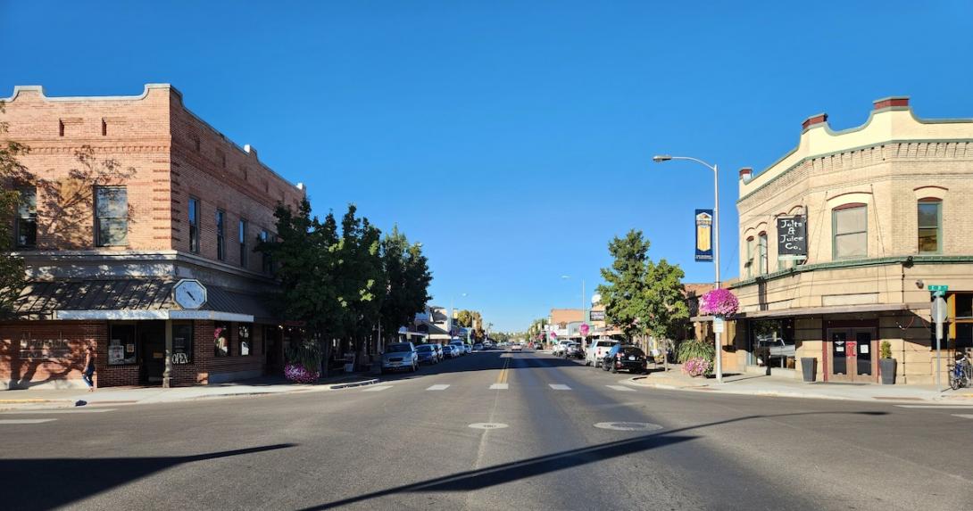 A historic downtown main street on a sunny day. Shops line the street.