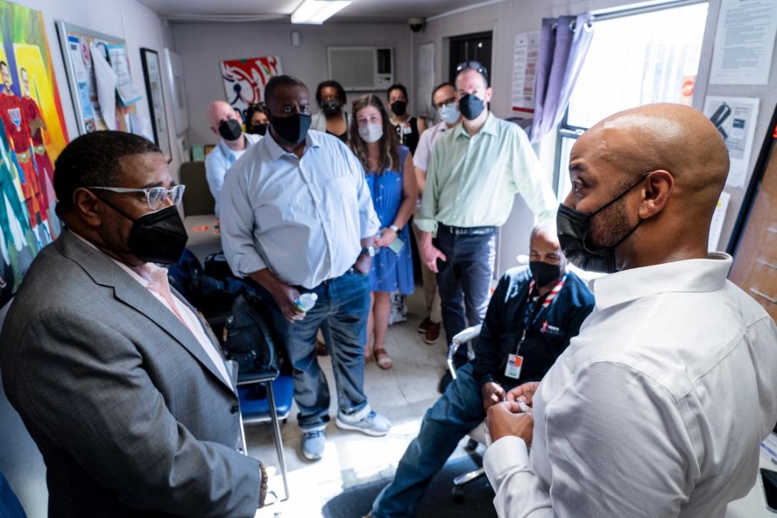 HIV University of Miami KFFHN Men and women wearing face masks meet in a hallway