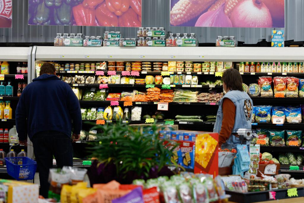 food on supermarket shelves people look at food on supermarket shelves