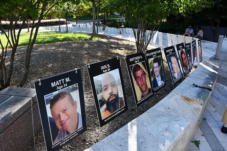 overdose deaths Stateline Tim Henderson pictures of young people displayed in a park-like setting.
