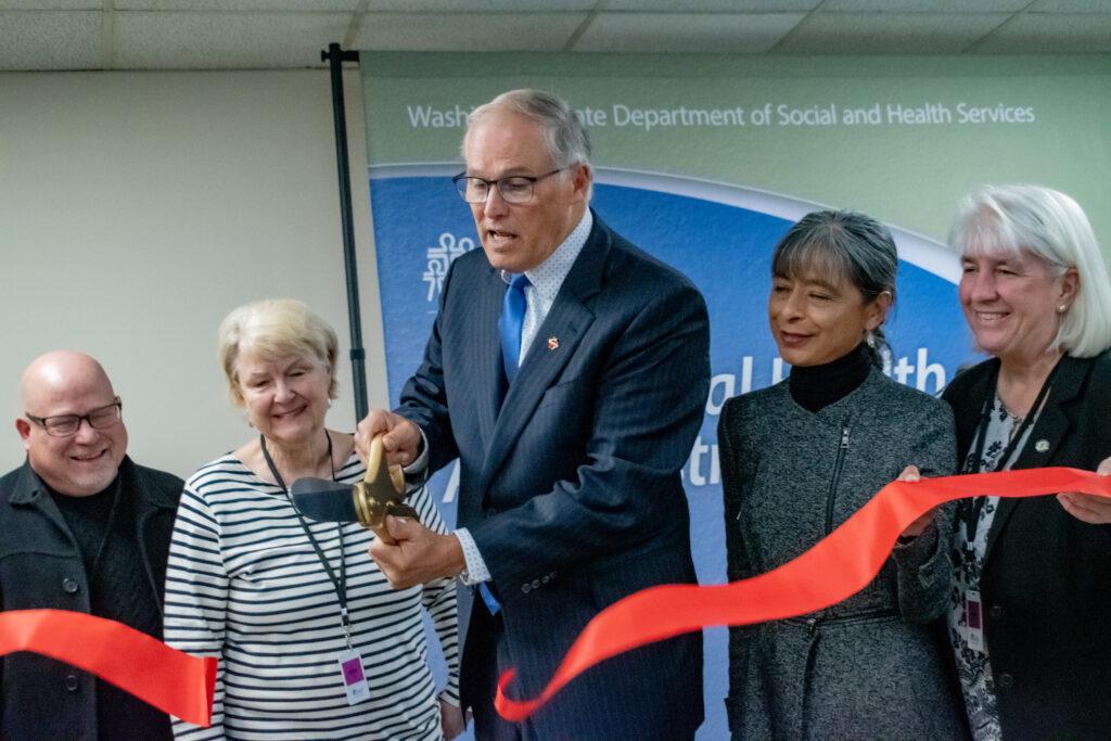 inslee wss man in suit cuts ribbon