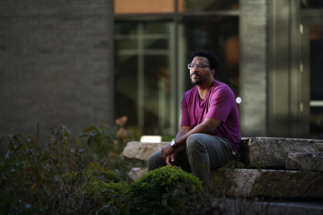 pensive man sits on a wall