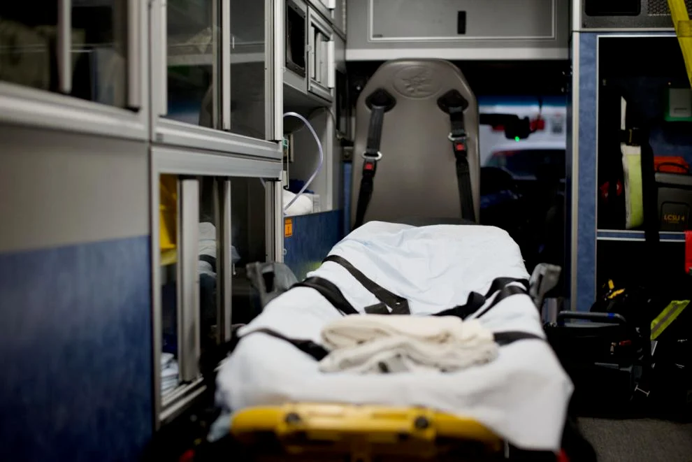 interior of an ambulance shows an empty gurney