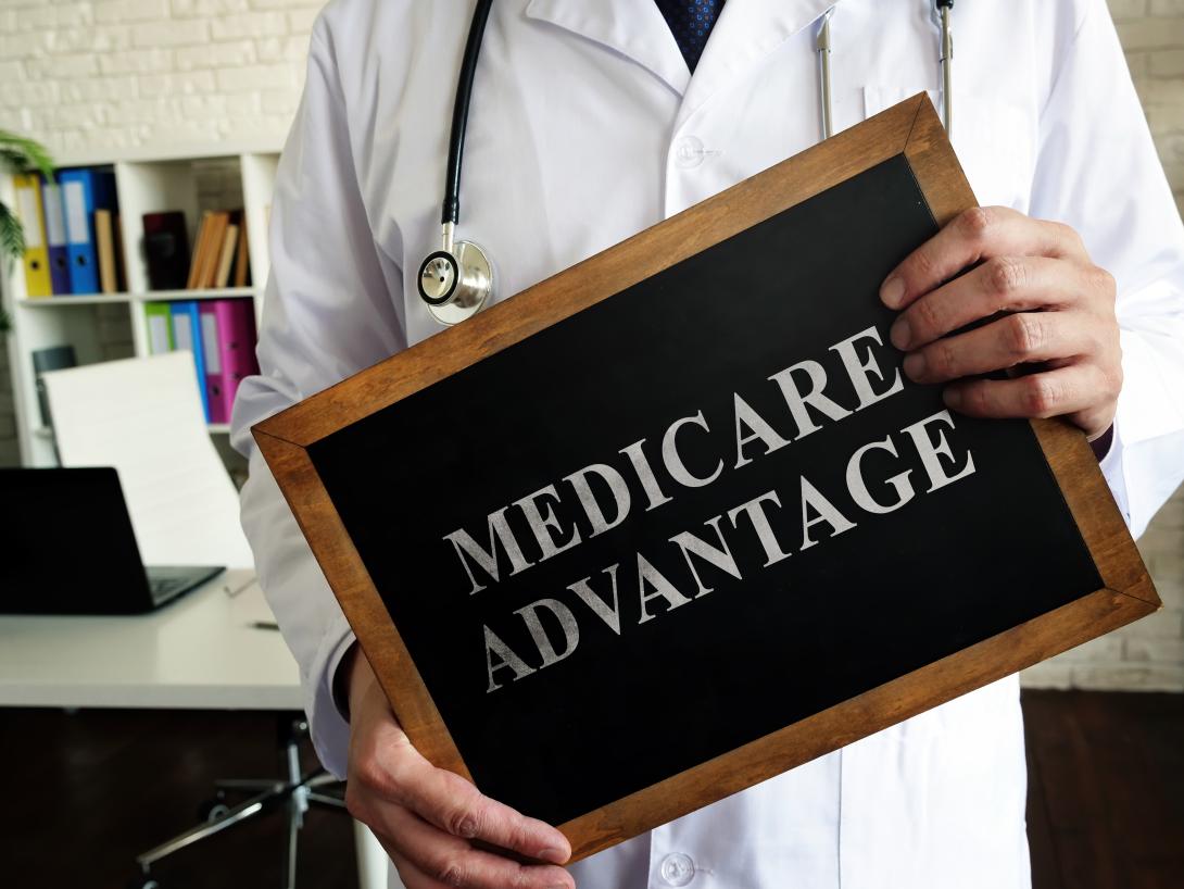 Illustration of doctor holding Medicare Advantage sign