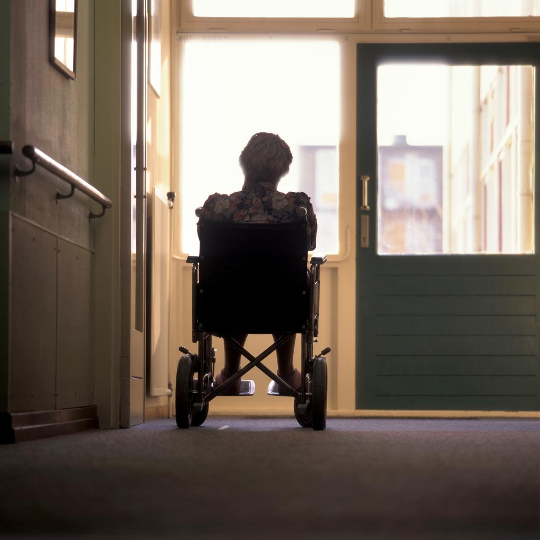 Person in wheelchair alone in hallway