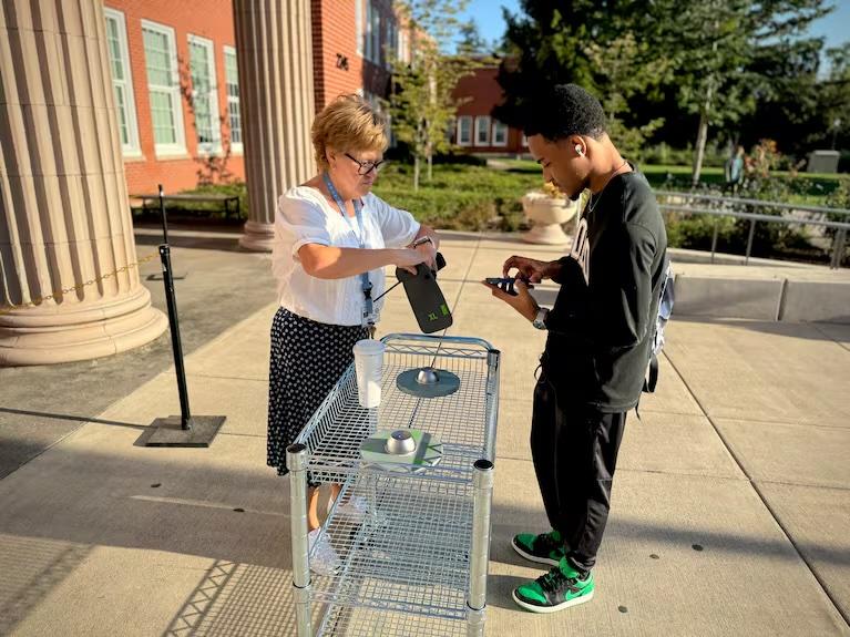 Vice Principal Jessika Magnett helps students use locking cellphone pouches at Grant High School in Portland, in 2024 Vice Principal Jessika Magnett helps students use locking cellphone pouches at Grant High School in Portland, in 2024
