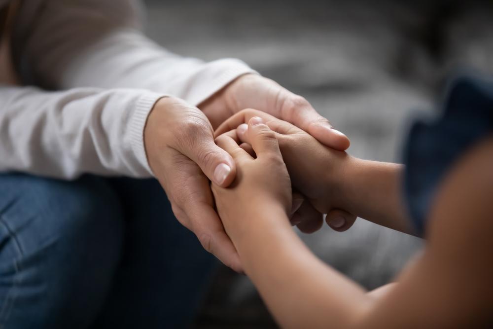 Child hands held by adult