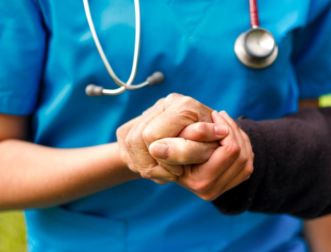 Doctor and patient hold hands Doctor and patient hold hands