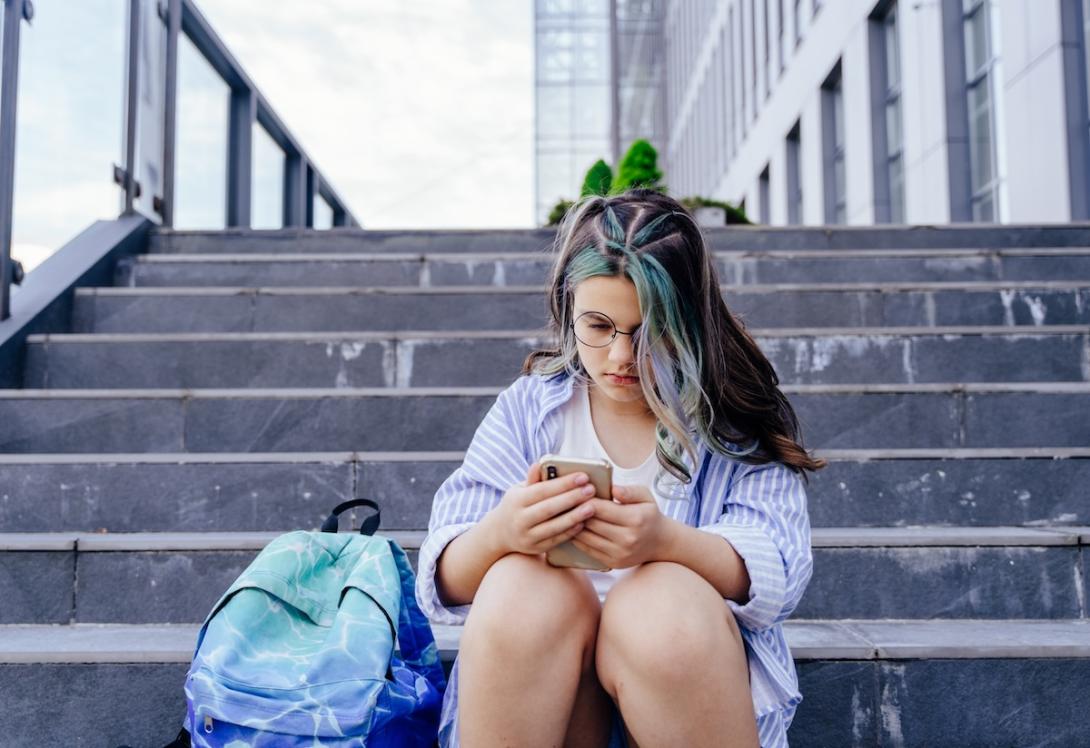 Girl distressed looking at phone Girl distressed looking at phone