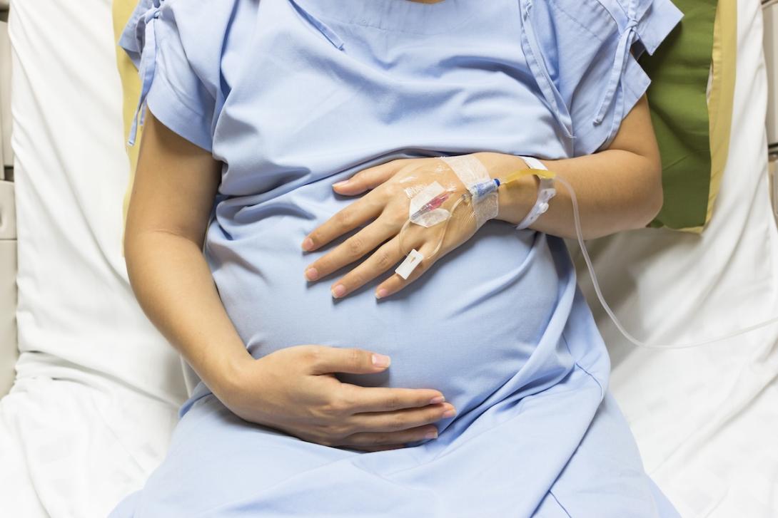Pregnant woman on hospital bed