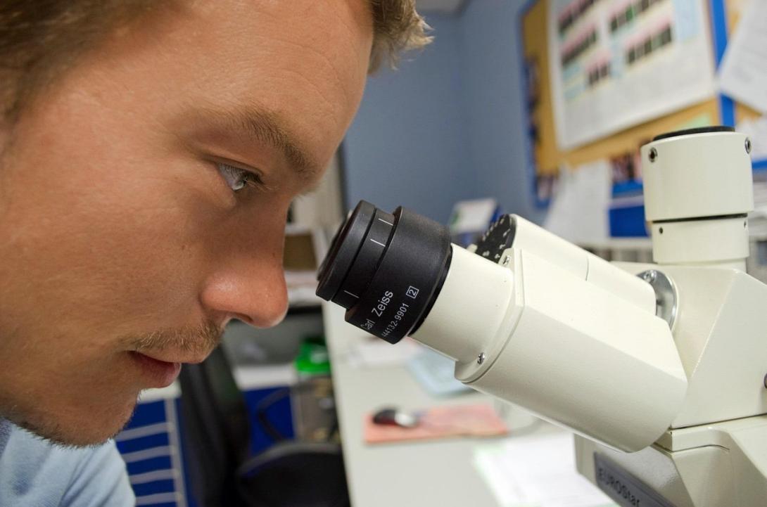 Man looks into a microscope