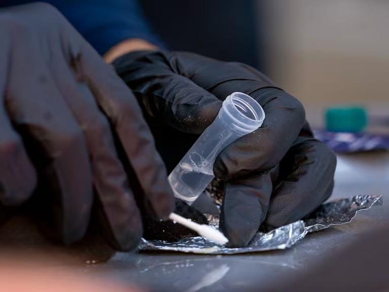 Portland Police officers use a fentanyl test kit during an arrest for drug possession in downtown Portland, Sept. 10, 2024