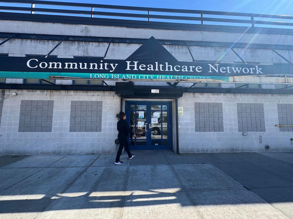 A woman walks into the Community Healthcare Network’s Long Island City Health Center in Queens, N.Y.