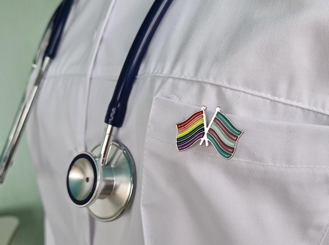 LGBTQ+ pins doctor's chest