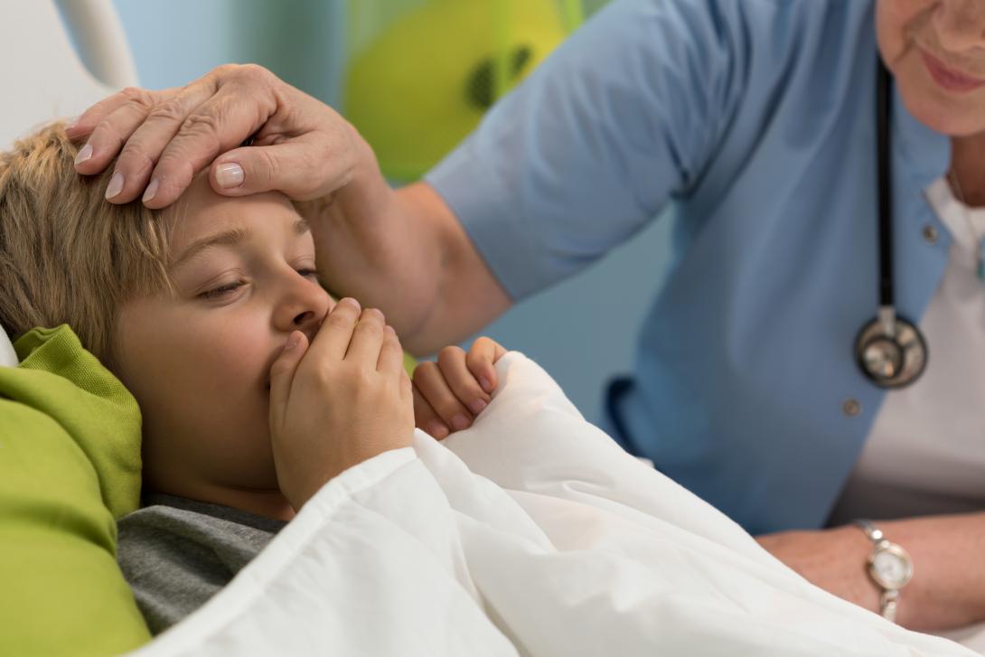 Coughing child being examined by health care provider