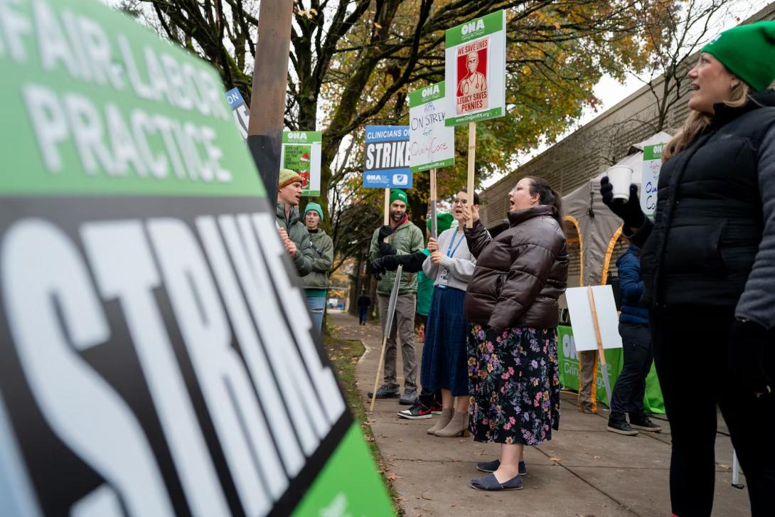 Advanced practice providers, including medical professionals like nurse practitioners, physician assistants and others, represented by the Oregon Nurses Association strike outside Legacy Health hospitals in Portland, Ore., on Dec. 3, 2025.  Eli Imadali / OPB