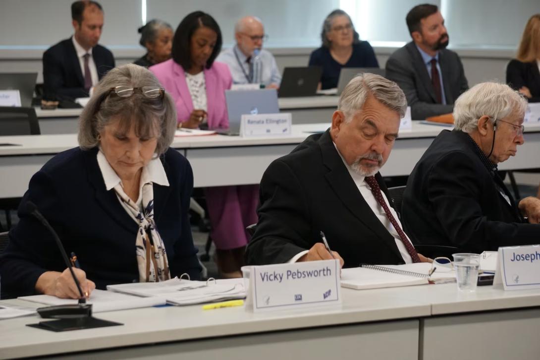 Members of the Advisory Committee on Immunization Practices, from left, Vicky Pebsworth, Dr. Joseph Hibbeln, and Dr. Raymond Pollak meet in Atlanta on Sept. 18. The panel is meeting again Thursday and Friday. (Rebecca Grapevine / Healthbeat)