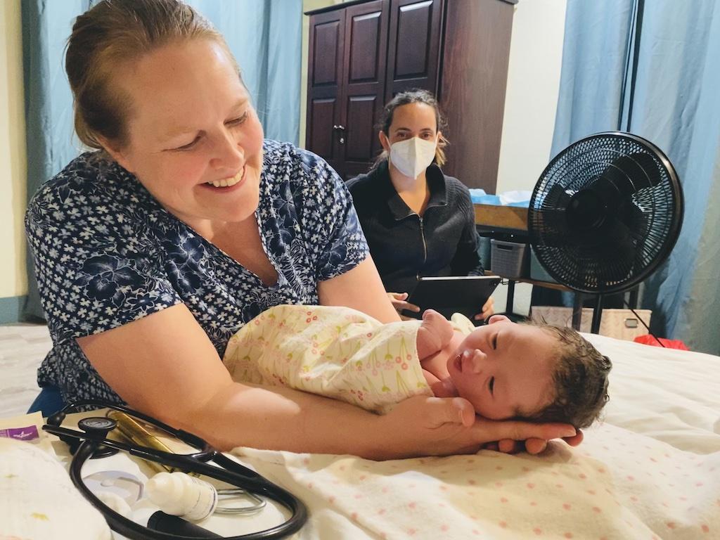 Midwife Sarah Simmons holds a newborn in Okanogan County, Wash.