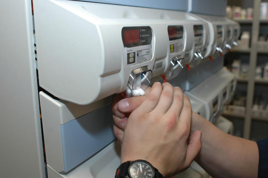 A prescription being dispensed through an automated machine.