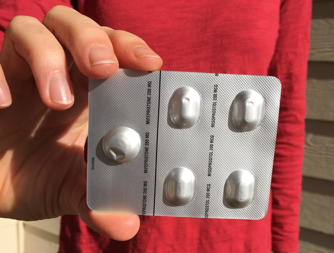 Mifepristone in a woman's hand