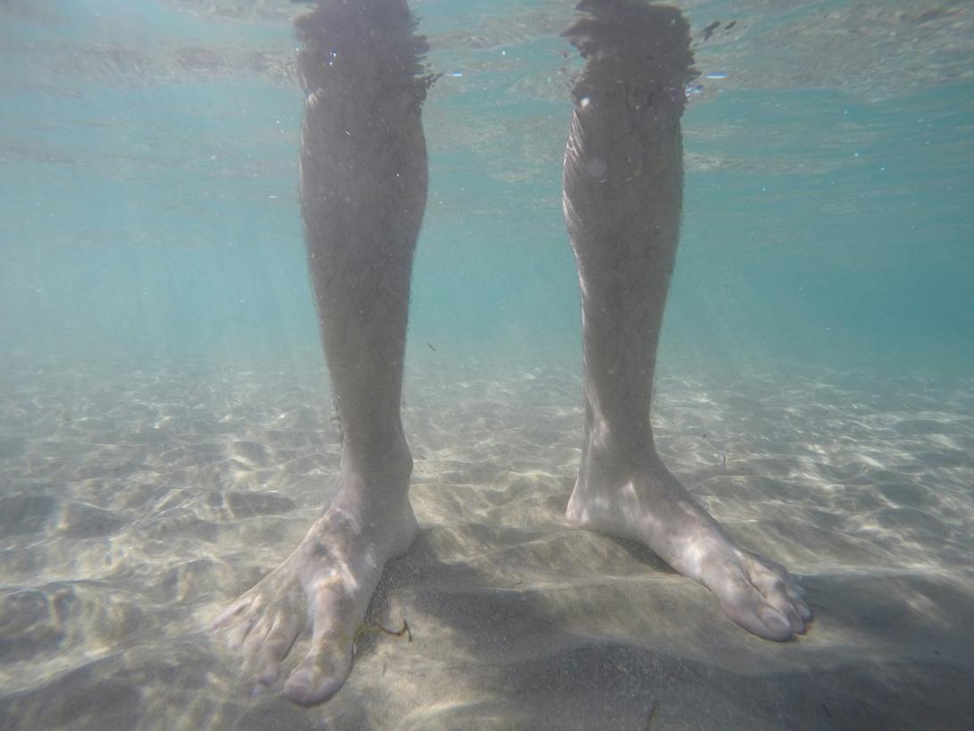 A man's feet in water