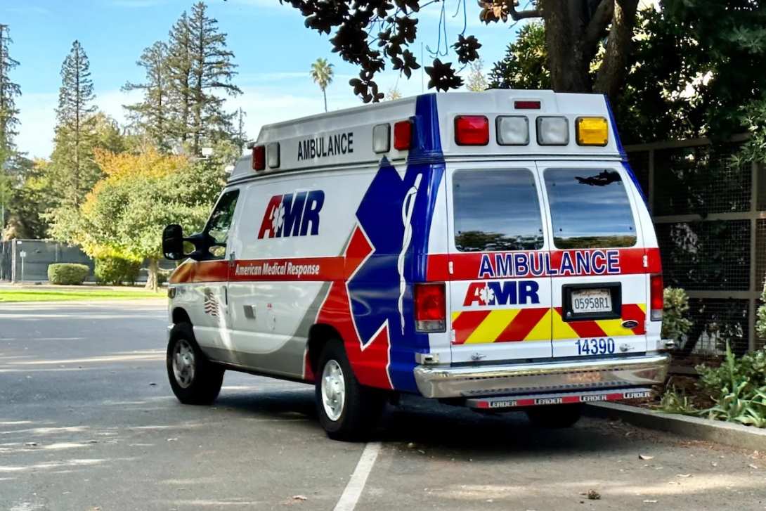 an ambulance sits parked in a parking lot