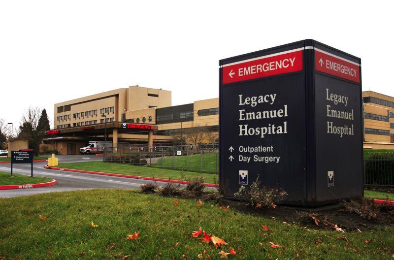 A sign directs people to the emergency department outside Legacy Emanuel hospital.