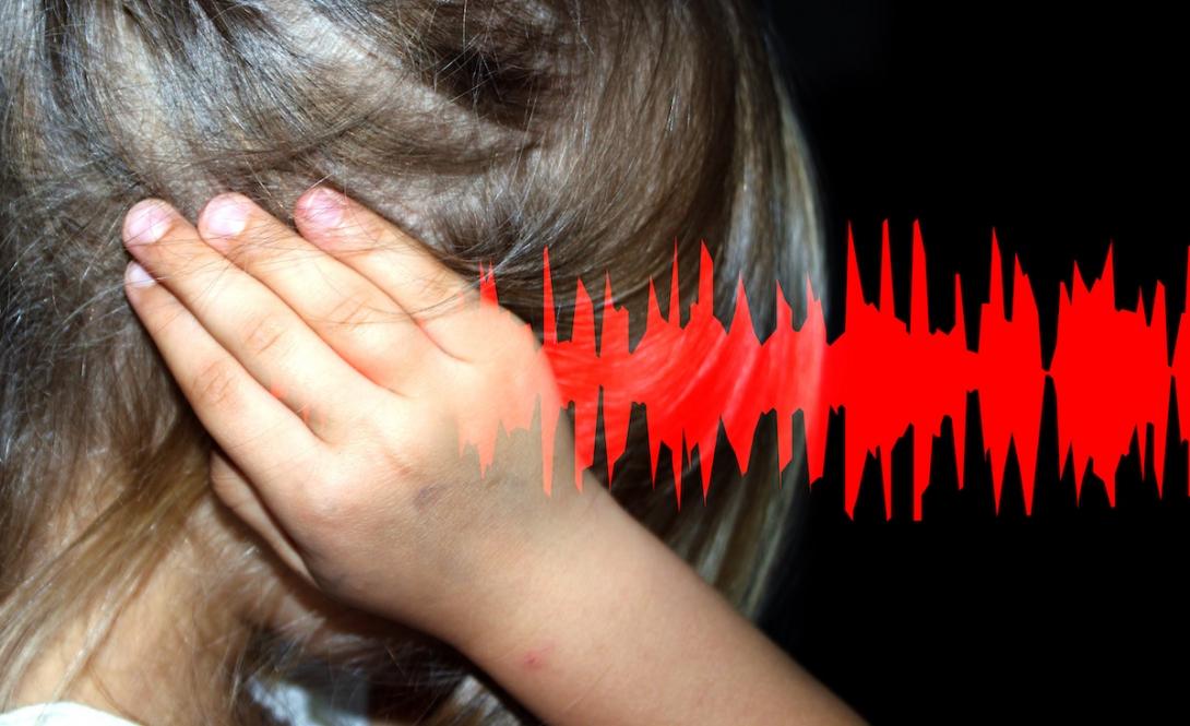 girl covers ear while sound wave attacks her