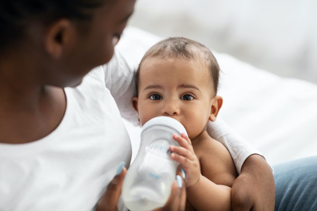 mother feeding baby using bottle